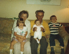 this is a picture of my grandma and grandpa brummer holding us and loving us!!
