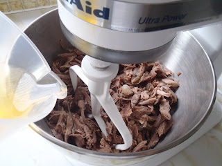Mixing the pulled confit, adding some of the cooking fat
