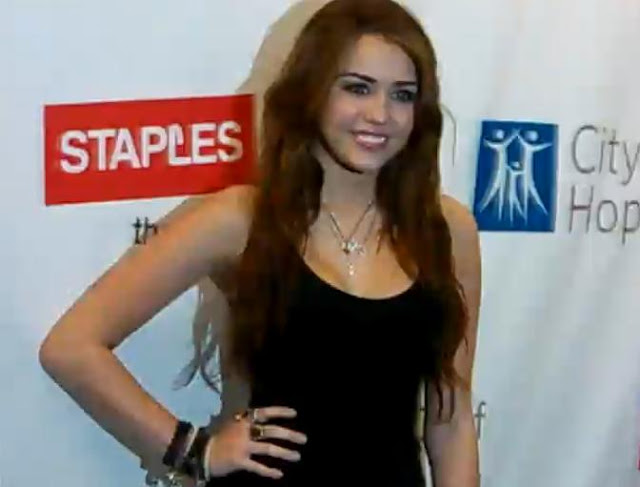 Miley Cyrus Taking Photo At City of Hope Concert Red Carpet