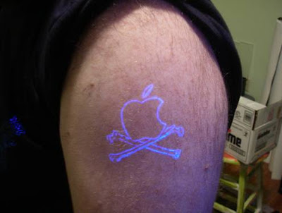 uv tattoo on shoulder with apple tattoo designs