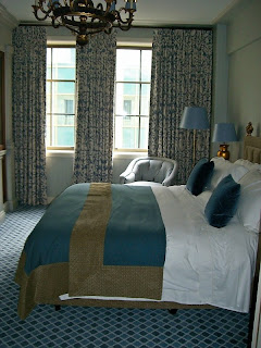 a bedroom with a bed and a chair