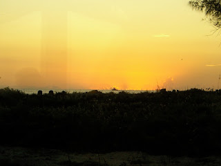 a sunset over a field