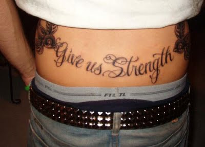 Give Us Strength - Text Tattoo on Lower Back
