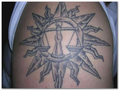 This is a typical Libra tattoo for men. The things around the zodiac sign