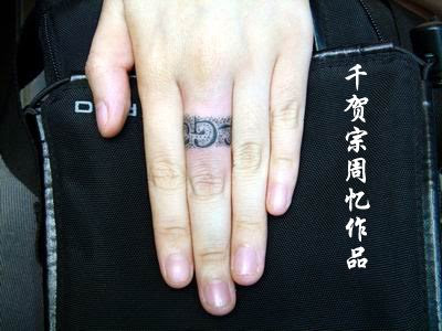 A very rare tattoo design. Not sure what is inked on the ring though.