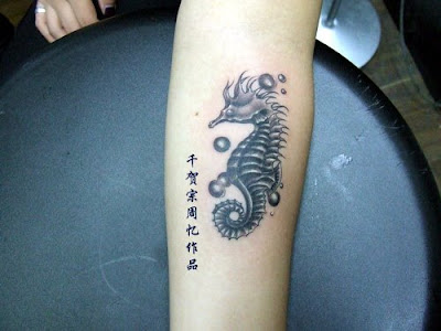 A cute seahorse tattoo on the ankle.