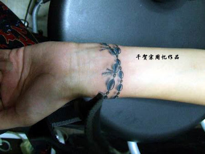 Rosary beads and cross tattoo on the ankle and foot. You can also look at