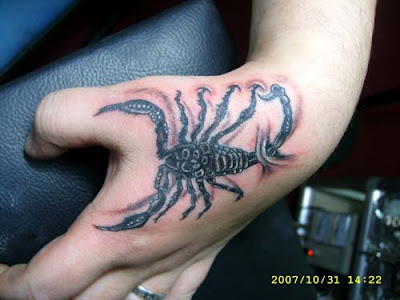 This free tattoo design shows a scorpion with its tail nailed on the wrist.