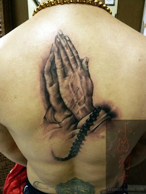 The prayer beads in the tattoo and the real ones around the neck is used to 