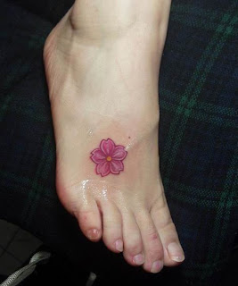 pink flower tattoo design on the foot