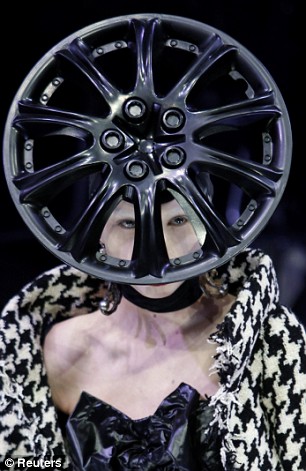 Model wearing a car rim hat at Paris Fashion Week