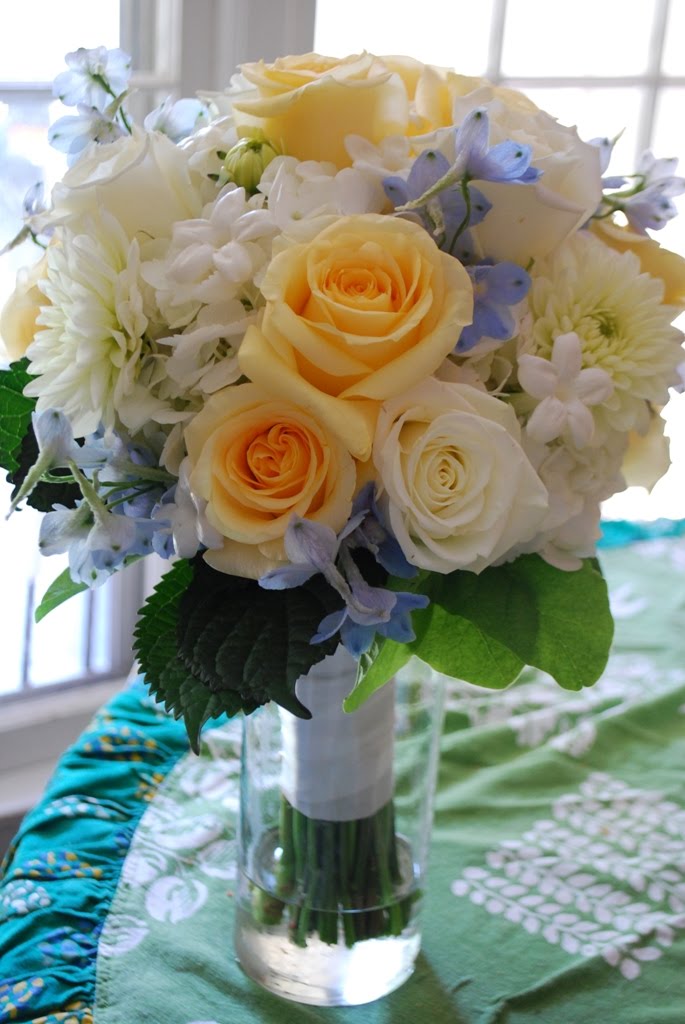 a bouquet of blue hydrangea yellow and white roses stephanotis 