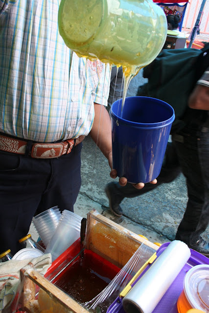 Selling honey by the jug near Oaxaca, Mexico