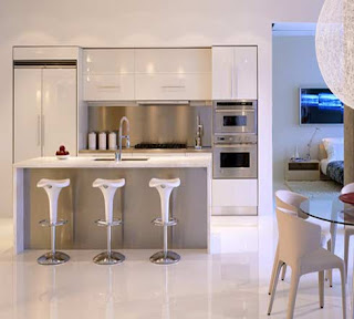 gloss white designer kitchen, black granite worktops,lots of stainless steel