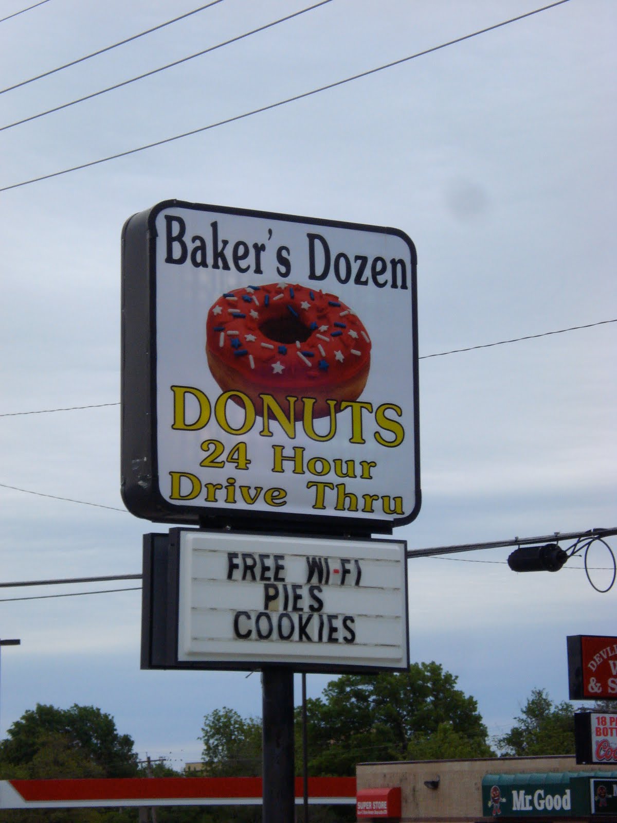 Penguin Eats Baker's Dozen Donuts Topeka, Kansas