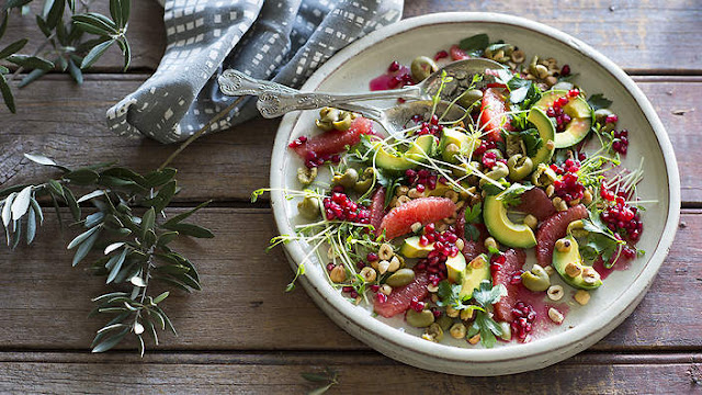 Smashed green olive and ruby grapefruit salad in a plate