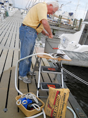 Fred the mason on the dock at Oriental, mixing concrete for his buoys.