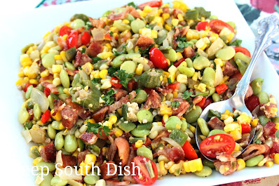 Basic lima bean and corn succotash gets a boost from summer bounty with the addition of sweet Vidalia onions, fresh tomatoes, bell pepper, okra and some smoked meat.