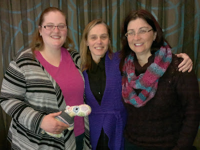Michelle, Jodie and Adrienne with Captain Poprocks in Michelle's hand. Captain Poprocks is wearing a grey poncho which matches the Sunday poncho that Michelle was making - grey with pink border details.
