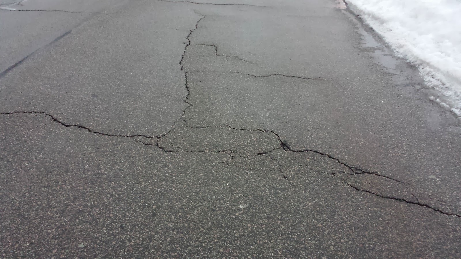 cracks like these may eventually create a pothole