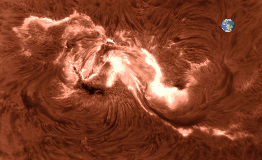 Erupce X9.3 s vloženou Zemí pro představu o měřítku