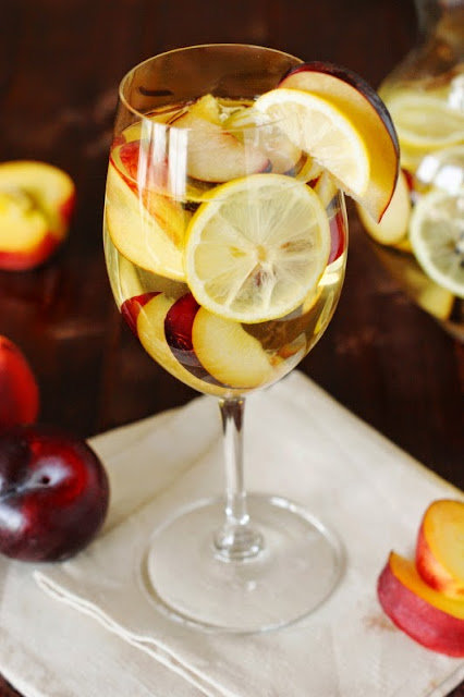 Glass of White Sangria with Nectarines, Plums, & Lemons Image