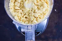 A view inside the food processor showing coarse crumbs for pecan pie bars shortbread crust