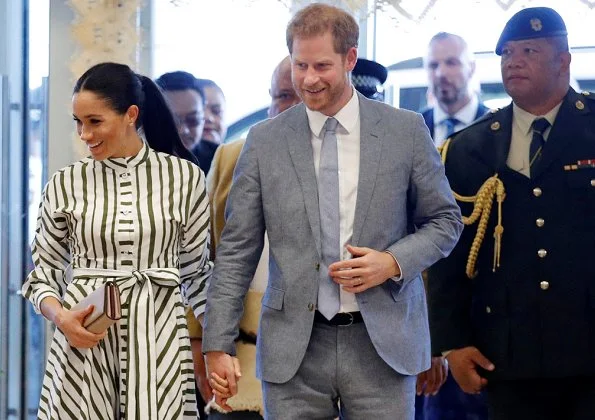 Meghan Markle wore Martin Grant Striped Shirt Dress from Spring Summer 2019 Collection, Prada Biblioteque clutch, Birks Quartz silver earrings.