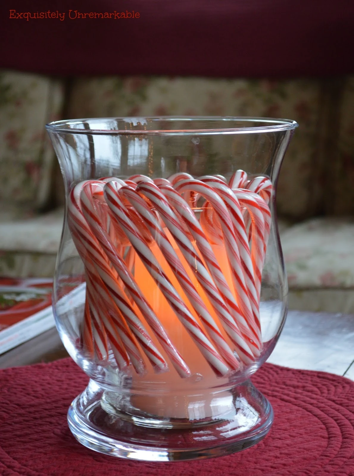 put candy canes in a hurricane candle holder