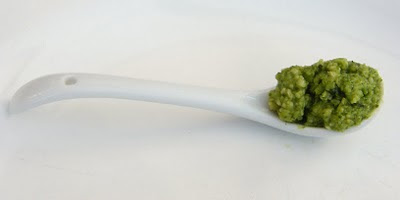 A dollop of Spinach and Pea Pesto on a white spoon