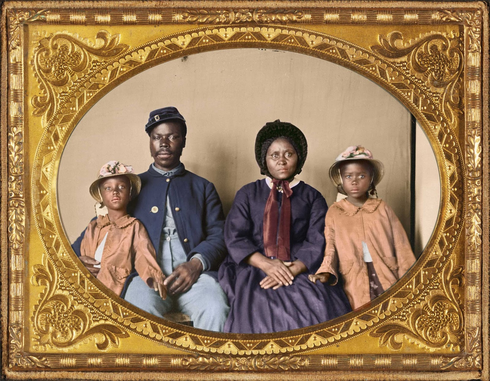X-slave who now serves with the Union forces sits for a portrait with his family.