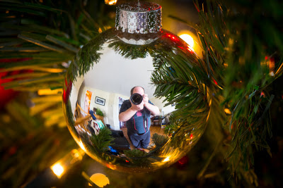 Scott takes a self-portrait in a reflective Christmas tree ornament.
