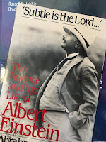 Subtle is the Lord: The Science and the Life of Albert Einstein, by Abraham Pais, superimposed on Intermediate Physics for Medicine and Biology.