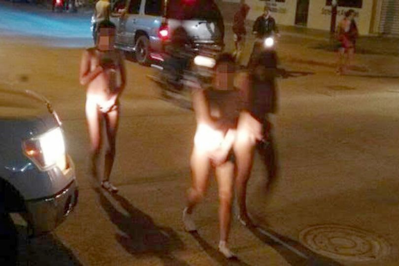 Three women accused of muggings forced to walk naked. 