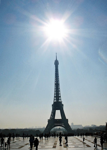 Eiffel Tower with bright sun above
