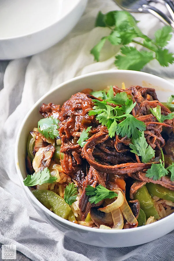 Serve up a deliciously satisfying dinner easily with this Beef Bowl Recipe. Leftover BBQ slow cooker brisket and fresh sauteed vegetables are served a top a bowl of rice and makes an easy dinner recipe everyone will love! #LTGrecipes