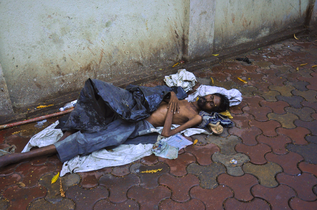 Man sleeping on the pavement near the Crawford Market in Mumbai, India. The number of poor people in India amounts to more than 300 million.