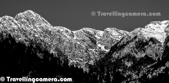 Shrikhand Mahadev in Himachal Pradesh is one of the most difficult Treks, I have done so far. All these photographs are more than 4 years old now, but memories are still fresh in our mind. This Photo Journey is sharing some of the black & White photographs shot during Shrikhand Mahadev Trek in 2008. Let's check out and know more about this wonderful place in Himalayas...Very first photograph shows a huge rock standing still on top of snow covered hill at the height of approximately 1700 feets. This place is of high importance for Shiva followers. This rock is considered as Shivling and every year various pilgrim come to this place from various parts of the country. This Trek opens in July for approximately 3 months. I remember the moment when this Trek was planned by Vikas, Vishal & Narender Ji... I was one of the passive member who was not involved in planning and other folks were best at it :) ... It was very quick plan... Three of us started from Delhi and all of us met at Shimla to start next journey. We went till Nirmand Town in our car and parked it there at some friend's home... From their, we hired a cab to drop us at Jaon Village. jaon village is base from where Shrikhand Mahadev Trek Starts. This whole stretch from Jaon to Shrikhand Mahadev peak was very beautiful with various herbs, plants and flowers on the way...This climb from Jaon to Shrikhand peak took 3 days and third day was mainly through rocky hills with not plants and most of them covered with snow... Last day was challenging one with last stretch was also creating some breathing problems for some of us.. So idea was to reach final destination, spend little time there and come back to Parvali Bag for spending night... During back journey we took 2 days to reach Jaon Village...Here is another photographs from third day of climb.. This place is just above Nain-Sarovar... I call it cloud store... Even this kind of clouds can't be seen from airplane... The size of hills in background will give you some idea about the diameter of this Cloud store.. It was most beautiful moment to see these clouds.. I wish I had a video to share this moment...Here is a photograph showing two of our friends climbing up through snow covered hill around Shrikhand Mahadev Peak. After this stretch some of us started feeling breathing problems but we managed to handle this through some of the medicines we were carrying with us..During this trek to Shrikhand Mahadev, clouds keep walking with you and at times start racing and of-course you can't compete with them :) ... Although these clouds make you most uncomfortable when they plan to throw heavy showers on you, while you have backpack on your shoulders and climbing high...Shrikhand Mahadev Trek is part of Great Himalayan National Park in Kullu District of Himachal Pradesh, India. Although route to reach the place is through Shimla town if you are coming from Delhi or Chandigarh... Weather on these hills is extremely unpredictable... Rains can start anytime... It's hard to see sun after 9am as clouds start moving from one place to another and whole day is spent with roaming clouds.. Most of the times, weather is good for trekking unless rain starts.. After first day, you don't even see trees where you can protect yourself from raindrops...Here is a photograph of fuggy day.. It was day one near Thachru which is one of the halts, where tents can be arranged for night stay but many folks target for Kali-Ghati or Parvati Bag on first day... We stayed at Thacharu as we didn't want to rush.. After first day of trek two of us were down with fever due to sudden change in weather and continuous trekking throughout the day...Here is a photograph of Shrikhand River which starts following you from Baghi-pul and during first day you have to walk through it or along the parallel paths during first half... A beautiful river with chilled water which comes from snow capped peaks around Shrikhand Mahadev Peak.Here is a photograph of Parvati Bag. This is the place which is targeted for first stay by many trekkers and for us it was very aggressive... So on first day we stayed at Thachru and on second day at Foolon ki Ghati which is next to Parwati bag....Lush green hills all around with shining white snow on the top and inside the corners of these hills.... Many of the water sources were also frozen on the way... At times, walking on those was extremely risky and you never know that which part of it has hallow below it...In some of the water streams, flow of water was very high during the day time and it used to increase as time passes in a day... During evening all of these streams used to get highest flow and slows down during night and cycle gets repeated.Here is a nother photograph of one of the hills covered with Hills... But this is much below the Shrikhand Mahadev Peak as we can see some tree in the bottom... This one is probably shot during first day or even on the way from Shimla to Jaon village...One of the rare photographs from Shrikhand Mahadev when we saw uncovered sky which was not wrapped by dense clouds..