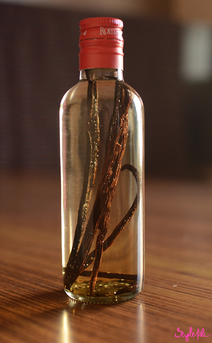 An image of vanilla beans immersed in a bottle of vodka to make a do it yourself project of how to make vanilla extract at home