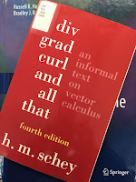 Div, Grad, Curl, and All That,  by H. M. Schey, superimposed on Intermediate Physics for Medicine and Biology.