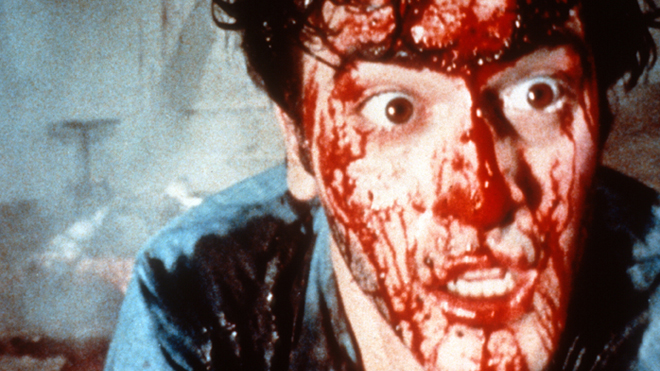 Bruce Campbell as Ash with a bloodied face in The Evil Dead
