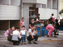 Ordinary People (unaware of camera), family street scene, Pyongyang, North Korea