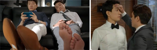 Suk Joo and Oh Jung Se 오정세 as Park Sang Tae play video games on the couch. / Sang Tae feels Suk Joo's forehead.