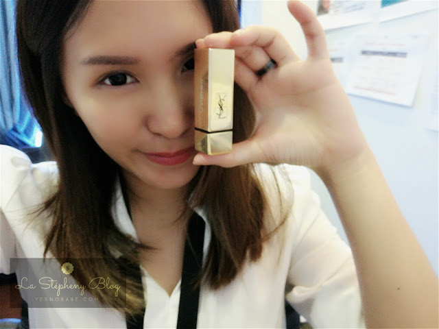 An asian chinese medium long hair girl holding a YSL lipstick in her hand showing her name engraved on it