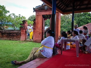 Balinese People In The Family Temple Waiting For Ceremonial Procession To Begin