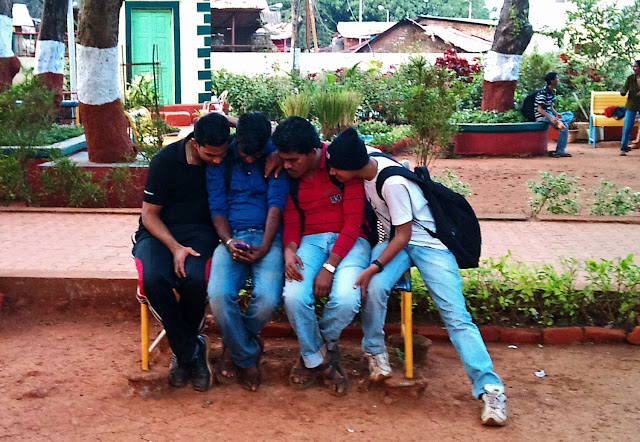 young students looking at cell phone