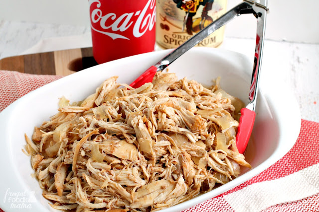 A classic cocktail is transformed into a delicious slow cooker meal that is perfect for game day (or any day!) in this Slow Cooker Captain & Coke Pulled Chicken recipe.