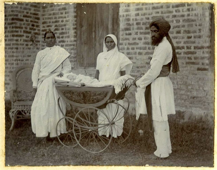 Three Indian Servants wih an European Baby in a Hand Driven Car - c1900s