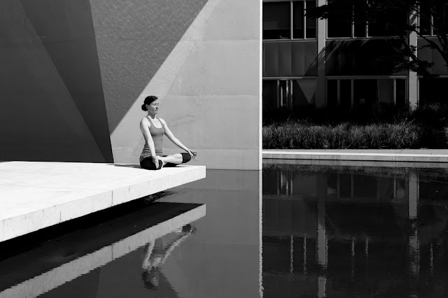 Woman meditating by water Woman meditating by water