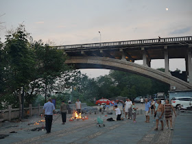 people burning ghost money near the Donghe Bridge in Ganzhou